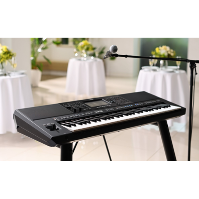 Yamaha Arranger Workstation PSR-SX920 at a party with a microphone stand. 