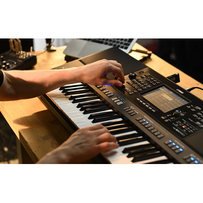 Close-up of the hand operating the Yamaha Arranger Workstation PSR-SX920.