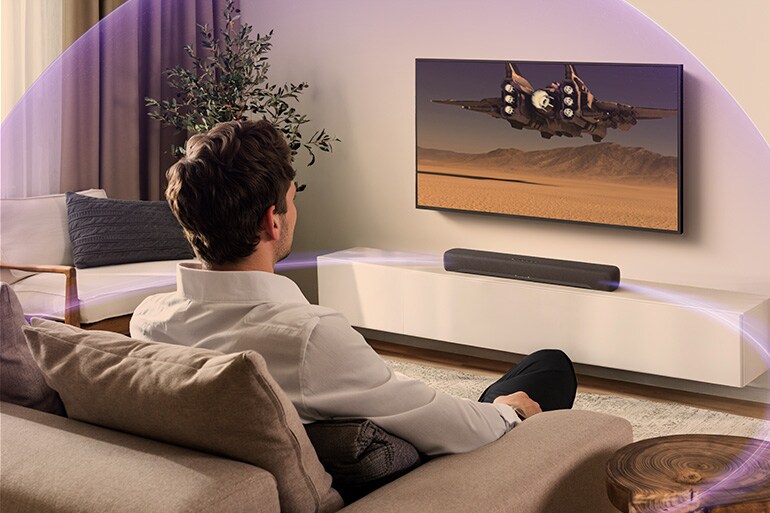 Person watching TV with a B200A and immersive sound effects