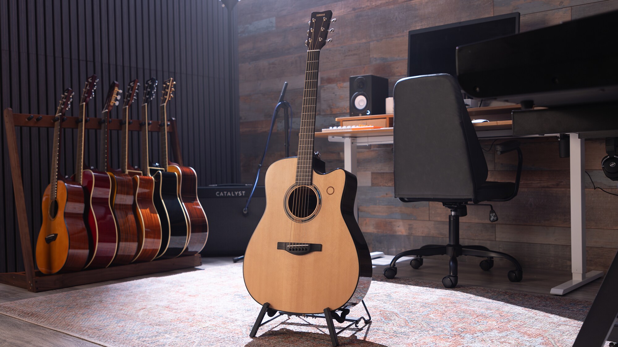 A TAG3 C acoustic guitar placed at the centre of a home studio