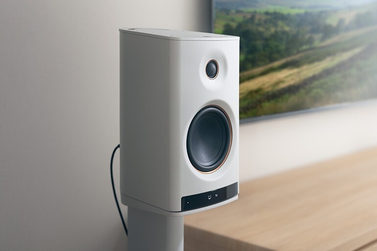 Close-up of the NX-70A speaker beside a TV