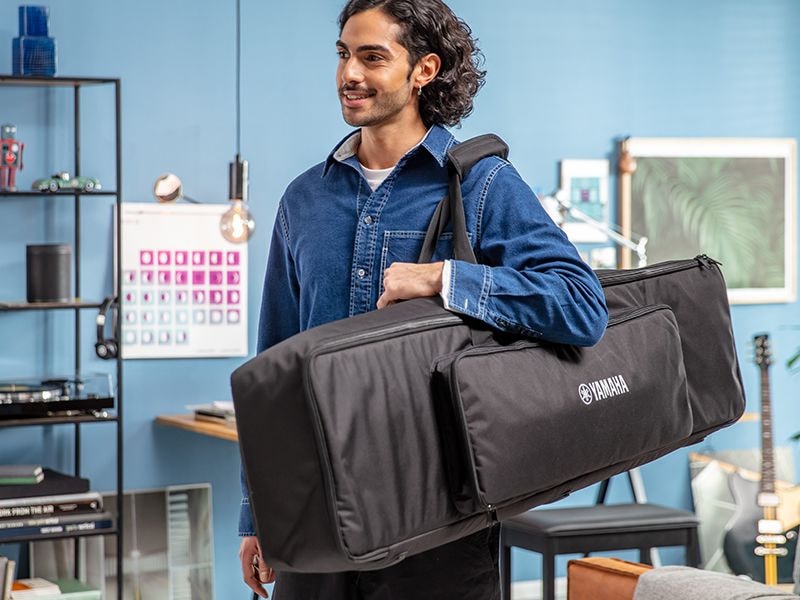 A person carrying the P-223 dedicated keyboard bag on their shoulder