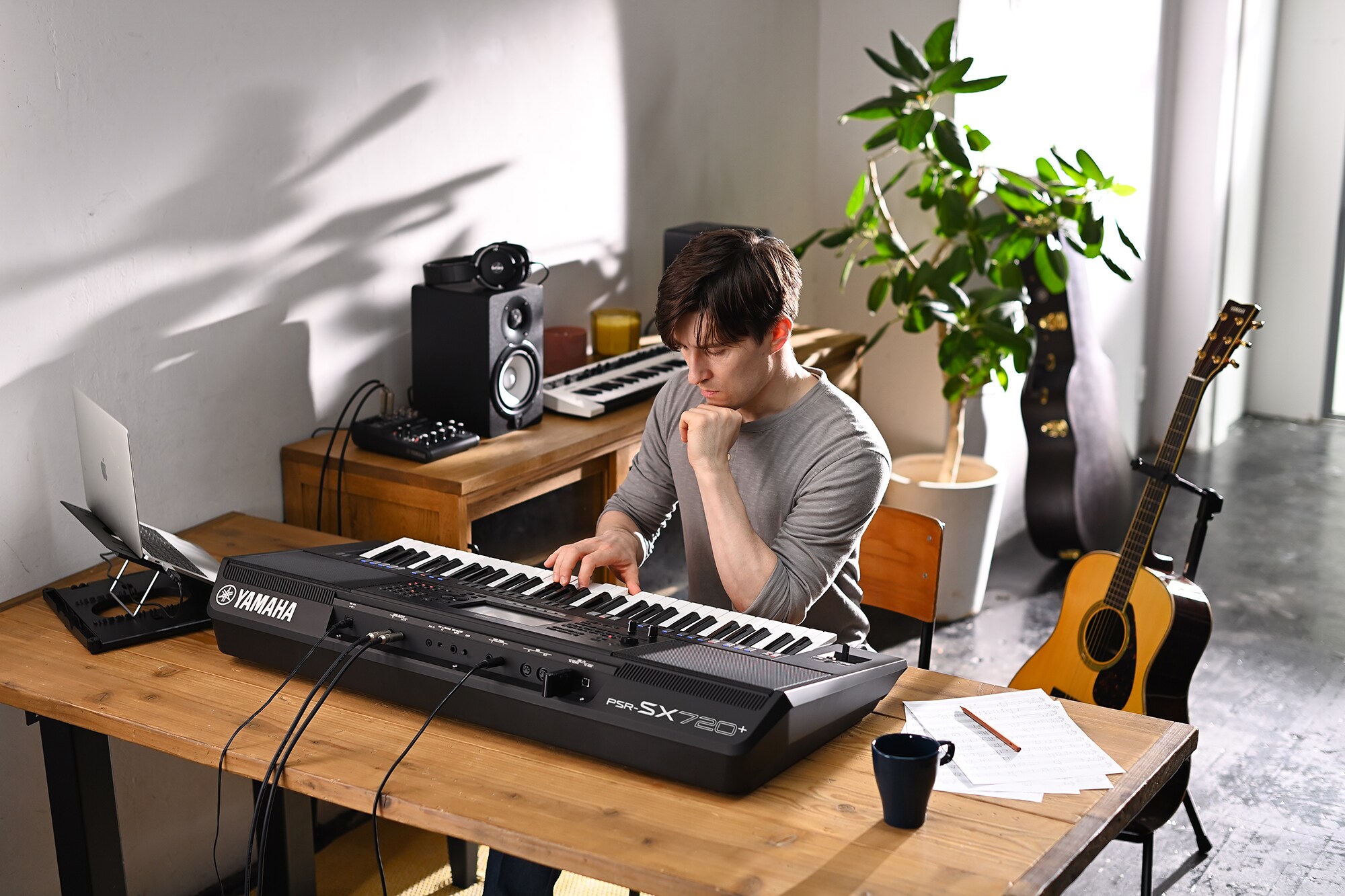 Photo of a person playing the Yamaha Arranger Workstation PSR-SX720+