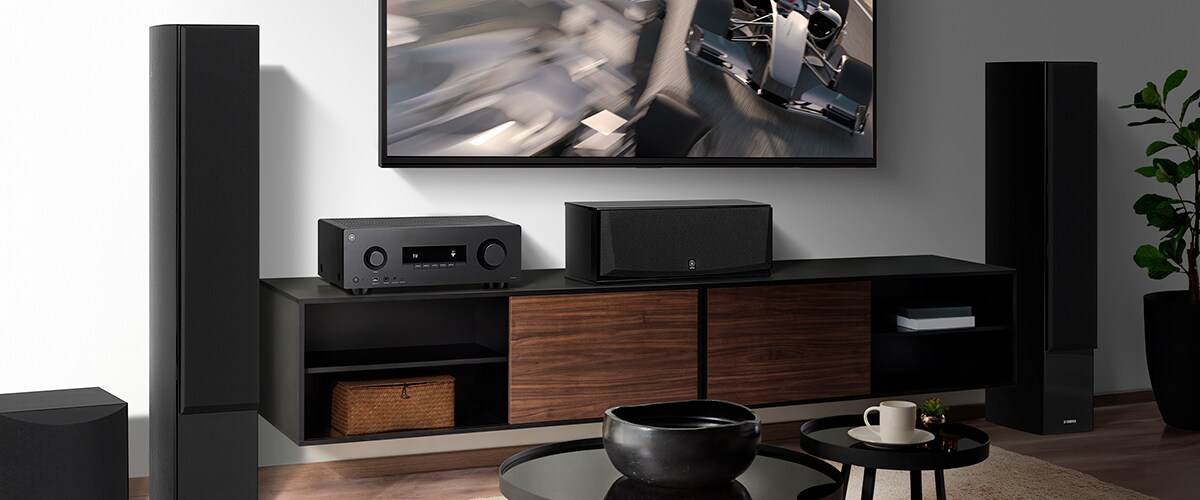 The RX300A, a centre speaker, front speakers and a subwoofer in a room.