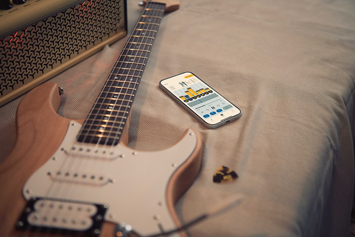 The Extrack music practice app close to an electric guitar and amplifier