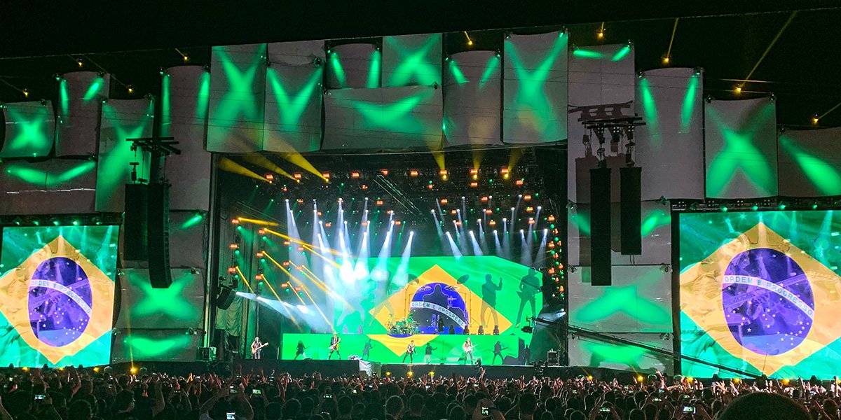 The Brazil flag shows up on multiple screens and light the stage up green at the Rock in Rio festival.